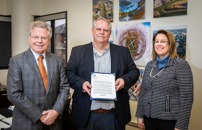 Andreas C. Cangellaris receives a letter from Brad Martin from the NSA Research Directorate that signifies the National Security Agency recognition of the Illinois as one of agencies featured schools, highlighting their relationship over more than 19 years with more than 100 Illinois graduates currently working at the NSA. Joining the group is Provost Susan Martinis,Vice Chancellor for Innovation and Research.